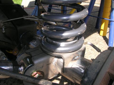 1996 Ford Bronco - A close-up view of the rear suspension of a 1996 Ford Bronco, showing a heavy-duty coil spring mounted on a modified differential housing.…