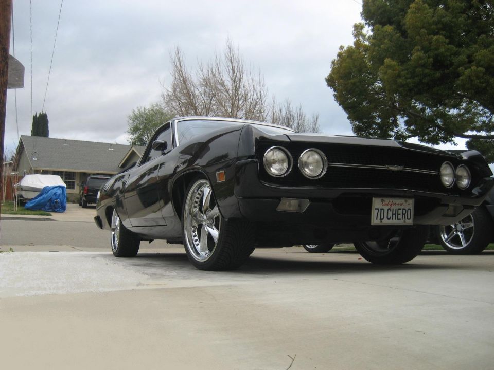 Black 1970 Ford Ranchero with chrome rims and a custom license plate.