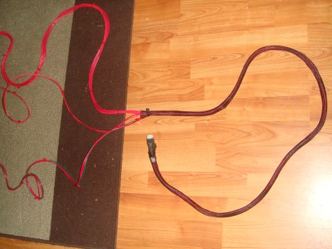 1992 Ford Bronco - A bundle of red wires and a single black wire with a white connector are laid out on a carpet and wooden floor.