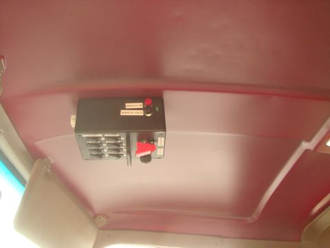 1992 Ford Bronco - A custom control panel with multiple switches and labels for winch operation is mounted to the red headliner of a vehicle. The panel includ…