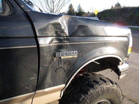 1996 Ford Bronco - Slid off road and hit a tree.
