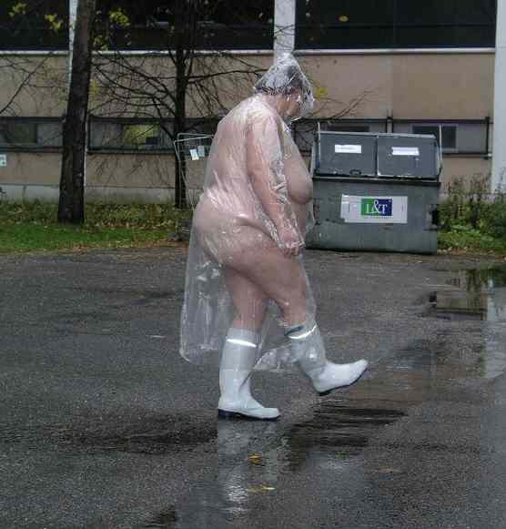 Person in a plastic bag poncho walking in puddles.