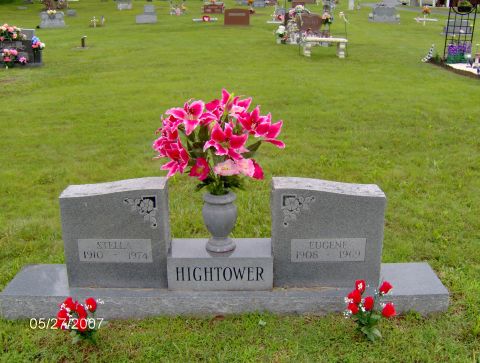 1978 Ford Bronco - A headstone with flowers in a cemetery. The headstone has the names Stella and Eugene with their birth and death dates.