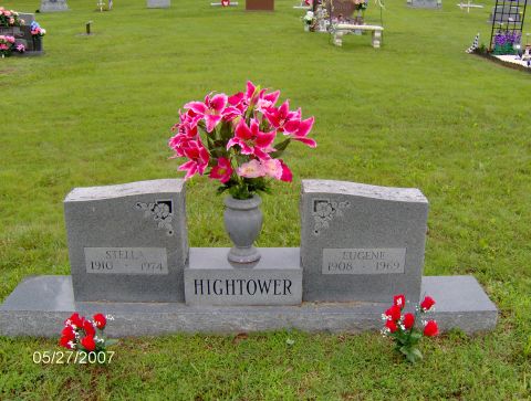 1978 Ford Bronco - A headstone with the names Stella and Eugene Hightower, along with their birth and death years, is adorned with a vase of pink lilies and a…