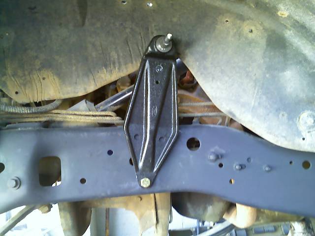 Close-up of a black metal bracket attached to a vehicle frame.