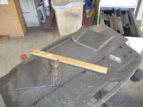 1996 Ford Bronco - A wooden ruler lies across two pieces of metal on a workbench. In the background, a cabinet is filled with various metal parts and a trash…