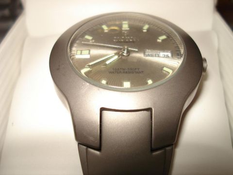2000 Ford Crown Victoria - A close-up shot of a watch face with the day and date displayed.