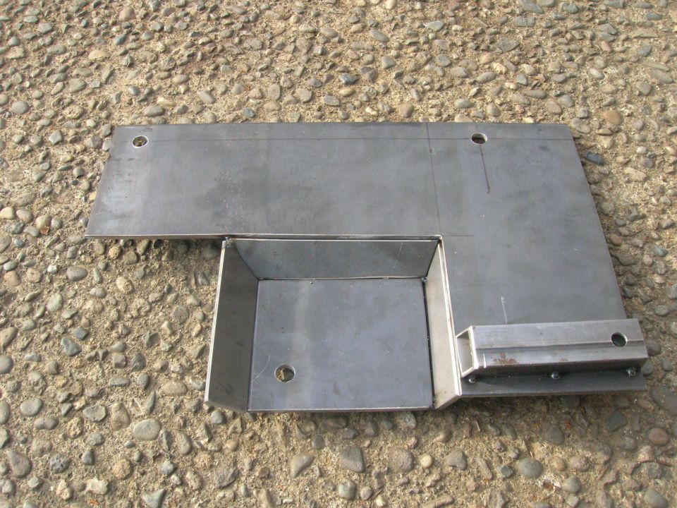 Custom metal bracket with box extension on gravel surface