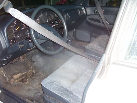 1991 Ford Bronco - Interior view of a car, showing the dashboard, seats, and seatbelt.