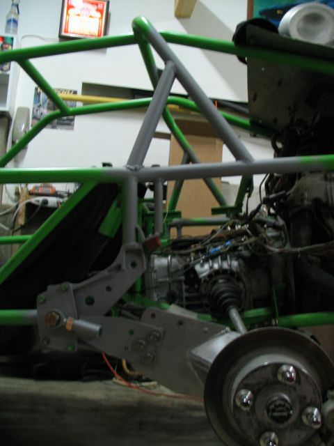 1987 Ford Supercrewzer - A custom-built vehicle chassis with suspension and engine parts is shown in a workshop setting.
