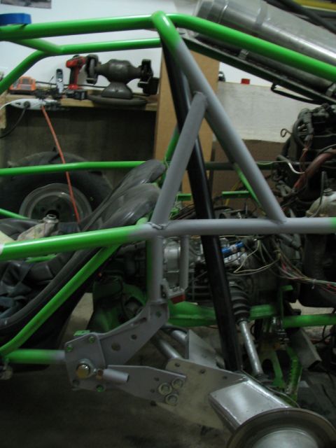 1987 Ford Supercrewzer - A close-up view of a custom-built vehicle chassis, revealing intricate suspension and engine components.