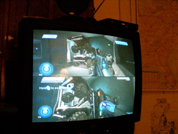 1979 Ford Bronco - Television displays a split-screen video game vehicles in a virtual world.