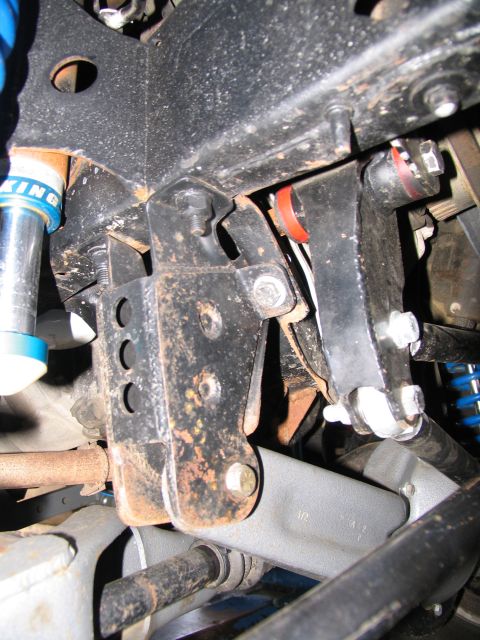 1984 Ford Bronco - Undercarriage view of modified suspension components, showing rust and aftermarket parts.
