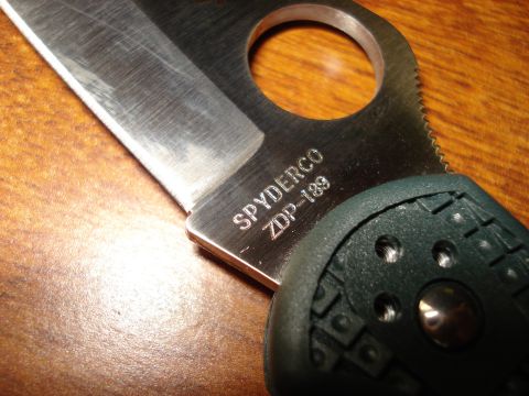 2000 Ford Crown Victoria - Spyderco ZDP-189 knife with serrated edge and textured handle shown on a wooden surface.