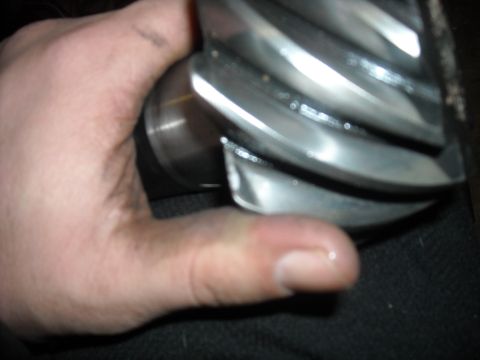 1979 Ford F-150 - A close-up shows a metal worm gear with distinct spiral teeth being held by a person's hand.