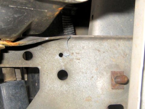 1996 Ford Bronco - The vehicle's frame shows a crack and signs of rust, indicating potential damage.