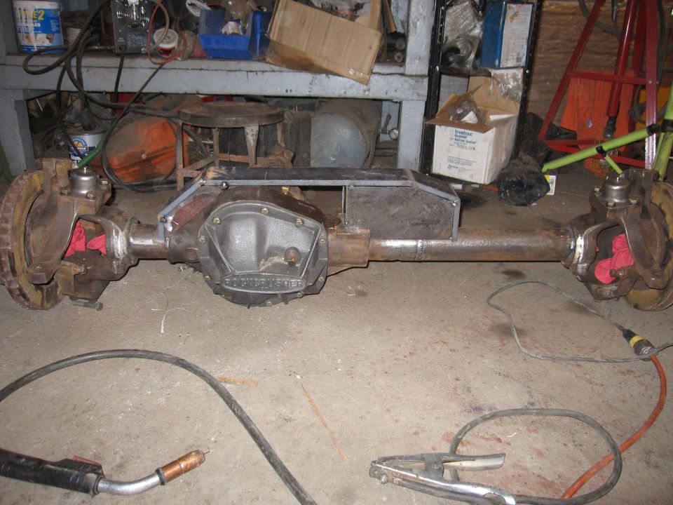 Ford Dana 60 axle assembly with welding equipment on concrete floor