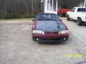 1993 Ford F-150 - A maroon Ford Mustang convertible is parked outside, with two trucks in the background.