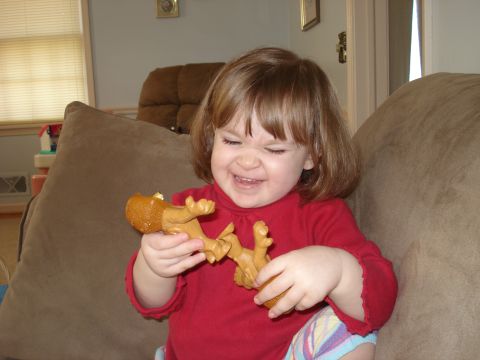 2000 Ford Crown Victoria - A young child sits on a couch, intensely focused on a toy lion.