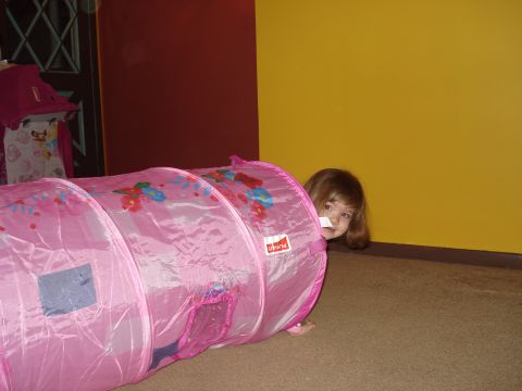2000 Ford Crown Victoria - A young child plays peek-a-boo from inside a colorful fabric tunnel.