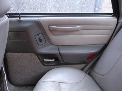 1989 Ford Taurus - Interior view of a 1989 Ford Taurus door panel, showing the window controls and armrest.