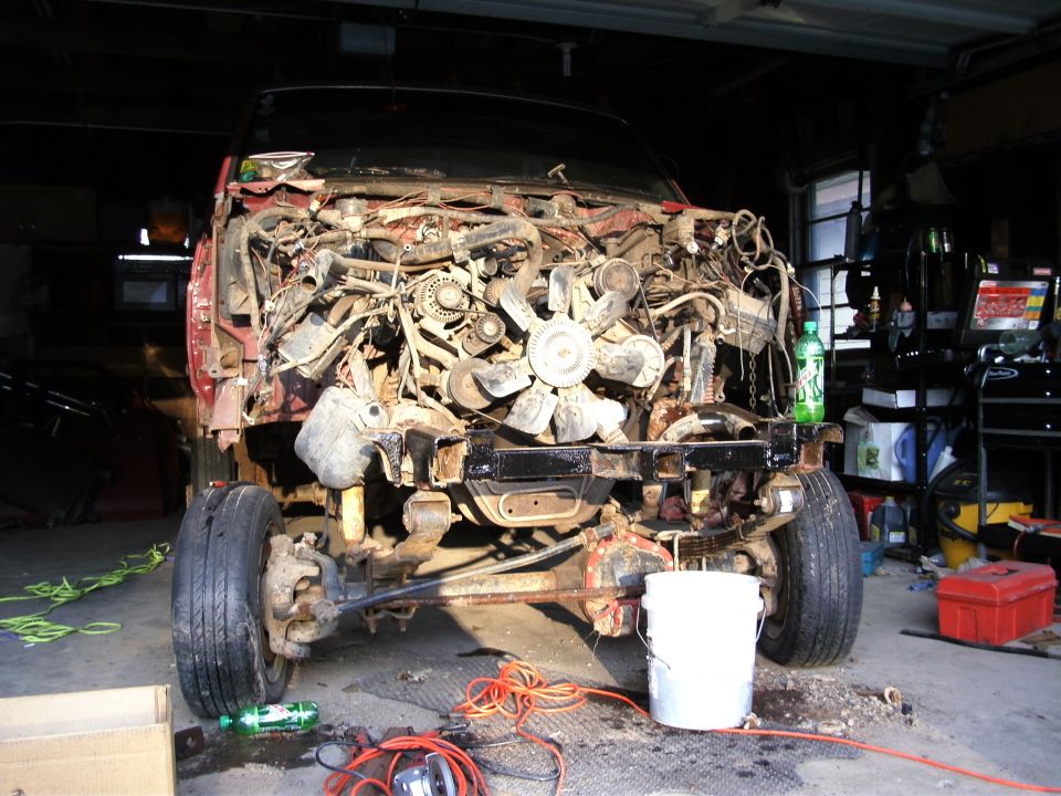 1994 Ford F-250 engine bay disassembled, showing engine and front suspension components
