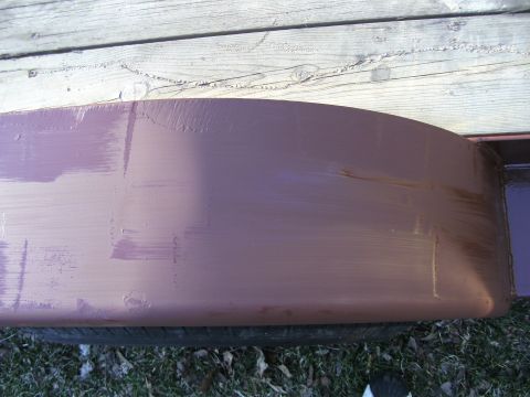 2005 Ford F-250 - A close-up view of a purple fender flare, showing brush strokes from recent painting. A tire is visible beneath the flare.