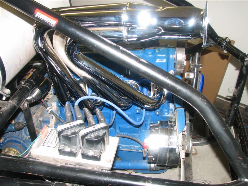 Blue V-engine with chrome headers and coil packs in a sand rail frame