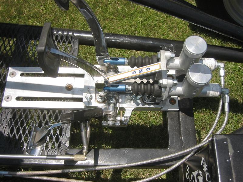 Sand rail front suspension with coilovers, master cylinders and braided brake lines on black frame