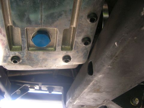 1996 Ford Bronco - Underside view of a vehicle's transmission pan and frame, showing mechanical components and structural parts.