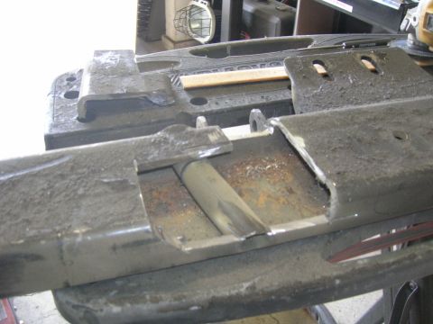1996 Ford Bronco - Close-up view of a heavily modified metal frame, showing cutouts and signs of rust.