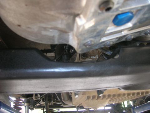 1996 Ford Bronco - Close-up of vehicle undercarriage showing transmission and suspension components.