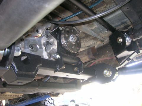 1996 Ford Bronco - Close-up view of modified rear suspension and drivetrain components on a vehicle.