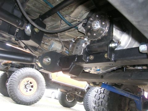 1996 Ford Bronco - Undercarriage view of a modified off-road vehicle with visible suspension parts and tires.