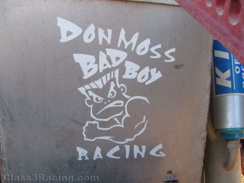1990 Ford Bronco - weathered body panel bears a white Don Moss Bad Boy Racing decal showing a snarling muscular cartoon figure beside a KING shock.