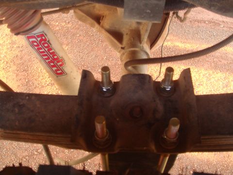 1992 Ford Bronco - Underside view of a vehicle's rear axle suspension with a Rough Country shock absorber visible.