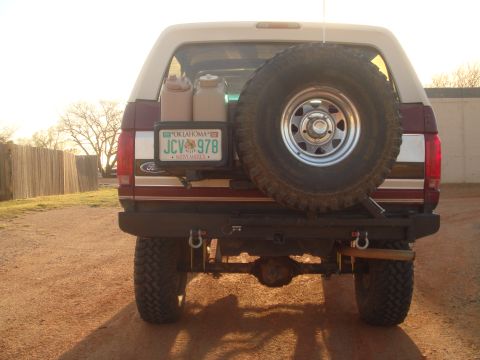 1992 Ford Bronco - Rear view of a 1992 Ford Bronco, equipped with a spare tire and two jerry cans.