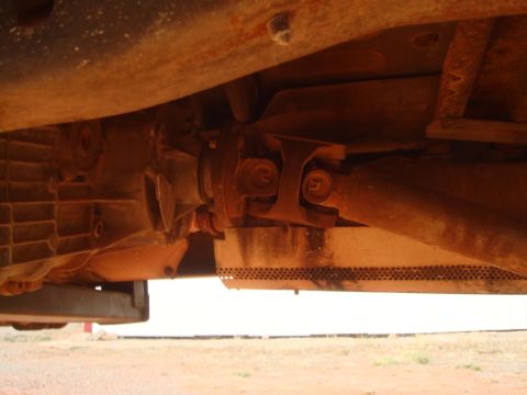 1992 Ford Bronco - Close-up of the vehicle's drivetrain components, including the transmission and driveshaft.