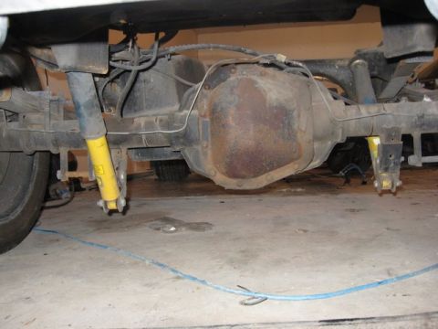 2007 Ford Mustang - Close-up view of a vehicle's rear axle and suspension system, showing the differential and shock absorbers.