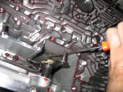 1995 Ford C-350 (Centurion Conversions) - Automatic transmission valve body detail, showing fluid channels and a manual adjustment.