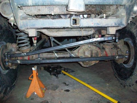 1992 Ford F-350 - Close-up of a vehicle's rear axle and suspension components, showing the differential and steering linkage.