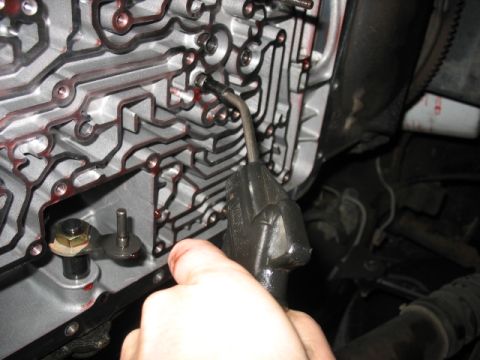 1995 Ford C-350 (Centurion Conversions) - Cleaning the intricate passages of a transmission valve body with a specialized tool.