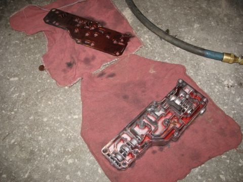 1995 Ford C-350 (Centurion Conversions) - Transmission valve body and gasket removed for service, resting on shop towels.