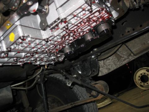 1995 Ford C-350 (Centurion Conversions) - The transmission pan and filter are visible, with red fluid indicating potential leaks or recent service.