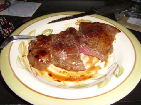 1978 Ford Bronco - A cooked steak is presented on a decorative plate, ready to be eaten.