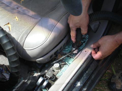 1989 Ford Taurus - Cleaning up broken glass from the car's interior after a break-in.