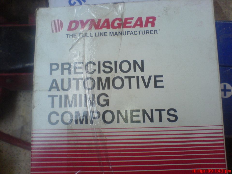Cardboard box with red and white stripes, labeled "DYNAGEAR PRECISION AUTOMOTIVE TIMING COMPONENTS"