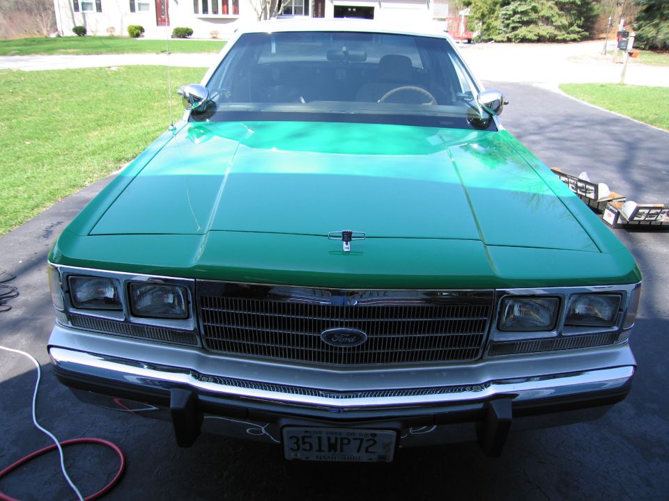 Front of green Ford sedan with quad headlights and plate 351WP72