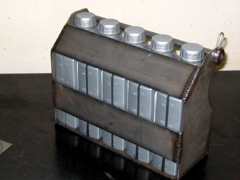 1996 Ford Bronco - A custom metal caddy is shown holding multiple bottles of oil, with measurement markings on each bottle.