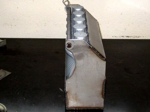 1996 Ford Bronco - A fabricated metal object with silver caps is shown from a side profile.